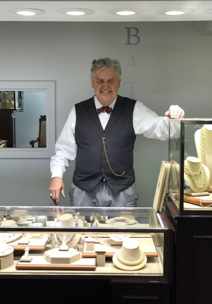 A man standing in front of a display case.